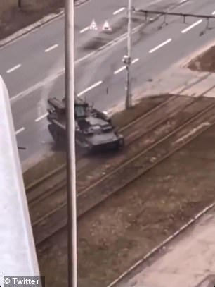 Pictured: A tank shown having crushed a civilian car in the middle of a Kyiv road